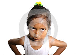 Head and shoulders portrait of sweet upset and disappointed 7 years old Asian girl looking intense to the camera feeling angry and