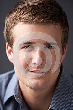 Head And Shoulders Portrait Of Young Man In Studio