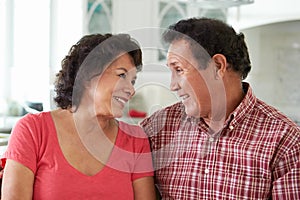 Head And Shoulders Shot Of Senior Hispanic Couple At Home