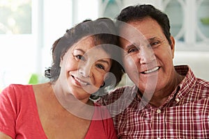 Head And Shoulders Shot Of Senior Hispanic Couple At Home