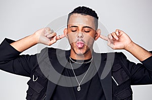 Head And Shoulders Studio Shot Of Man Pulling Faces And Smiling At Camera