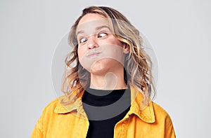 Head And Shoulders Studio Shot Of Woman Pulling Faces And Smiling At Camera