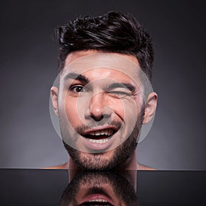 Head of winking young man