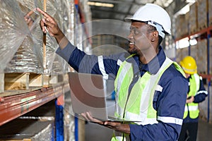 Head of worker in an auto parts warehouse, Examine auto parts that are ready to be shipped to the automobile assembly