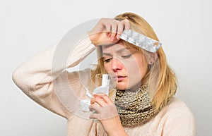 Headache and fever remedies. Woman tousled hair scarf hold tablets blister. Guidelines for treating fever. Take