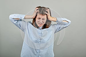Headache grimacing pain holds back of neck indicating location. Fatigue during