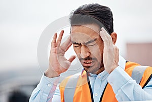 Headache, stress and male construction worker on a rooftop of a building for inspection or maintenance. Migraine