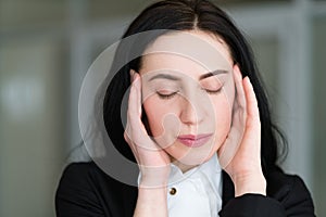 Headache stress tiredness woman massaging temples