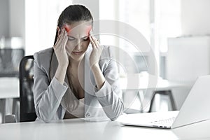 Headache and Stress at Work. Portrait of Young Business Woman at