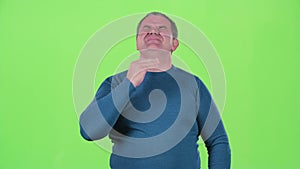 Headache torments middle aged man. Green screen
