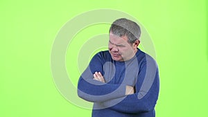 Headache torments middle aged man. Green screen. Slow motion