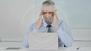 Headache, Upset Senior Businessman in Stress at Work