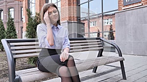 Headache, Upset Woman Sitting Ouside Office Building on Bench