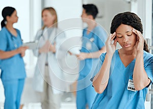 Headaches can get to anyone. Shot of a medical practitioner looking stressed in the middle of a meeting in hospital.