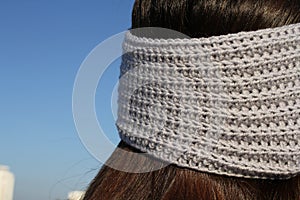 Headbands crocheted knitted on the street on the girl. Product listing for sale. Urban style. Fashion.