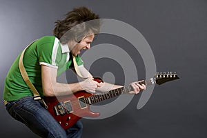 Headbanging guitarist playing an electric guitar