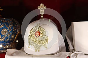 Headdresses of priests on a red background