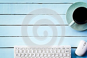 Header for technology concept,Example keyboard with coffee cup on blue table.Top view.