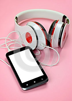 Headfones and smartphone on pink background.