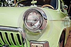 Headlamp of tuned old vintage car, close up. Low rider auto