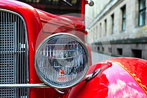 Headlamp of vintage red car photo