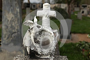 Headless angel. Destroyed tombstone at the abandoned cemetery.