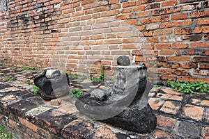The headless Buddha statues sitting on pedestal.
