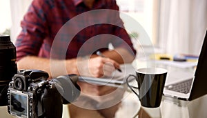 Headless crop of a photographer at his home workspace