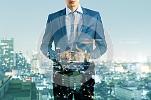 Headless young businessman silhouette in suit standing on creative night city background. Future, success and career concept.