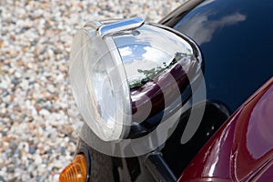 Headlight chrome old beautiful car on floor background