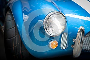 Headlight Detail of Blue Classic car