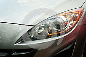 Headlight of grey car