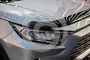 Headlight of grey modern car with LED light