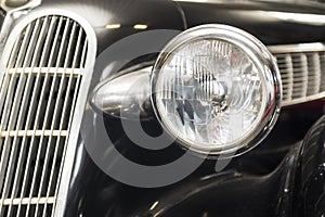 Headlight lamp vintage car. Headlight lamp vintage classic car. Front part with the headlight retro car closeup