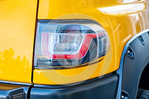 Headlight of modern prestigious car closeup, yellow color