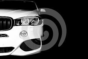 Headlight of a modern white sport car. The front lights of the car. Modern Car exterior details. Car detailing. Isolated on black