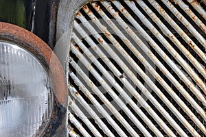 Headlight of an old rusty abandoned car, utilisation and scrap concept