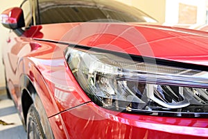 close up headlight of red car, transportation industry