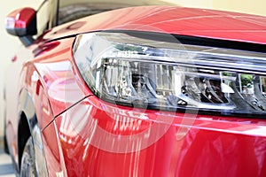 close up headlight of red car, transportation industry