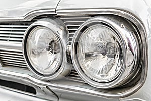 Headlight of a vintage retro old car automobile vehicle.