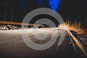 The headlights of a car on mountain road in the night