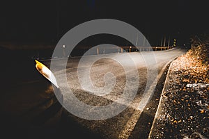 The headlights of a car on mountain road in the night