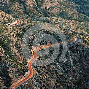 Headlights of car in winding road in the desert near Tuscon, Arizona