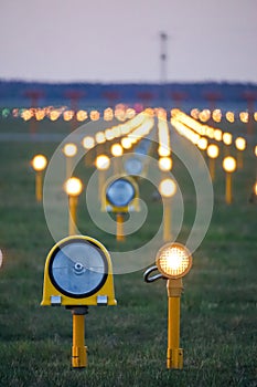 Headlights of runway lights at the airport on the background of the evening sky