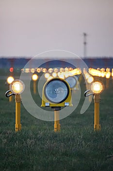 Headlights of runway lights at the airport on the background of the evening sky