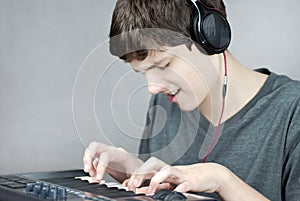 Headphone Wearing Teen Plays Keyboard