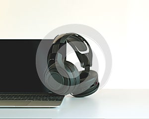 Headphones black and laptop on Work Desk.