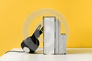 Headphones on book. Audiobook horizontal banner with copyspace. Online education and e-learning concept