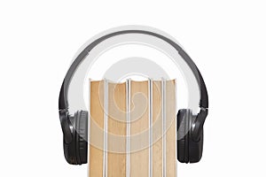 Headphones on books isolated on white background. Audio books isolated. Listening audio.