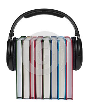 Headphones on books on white background.